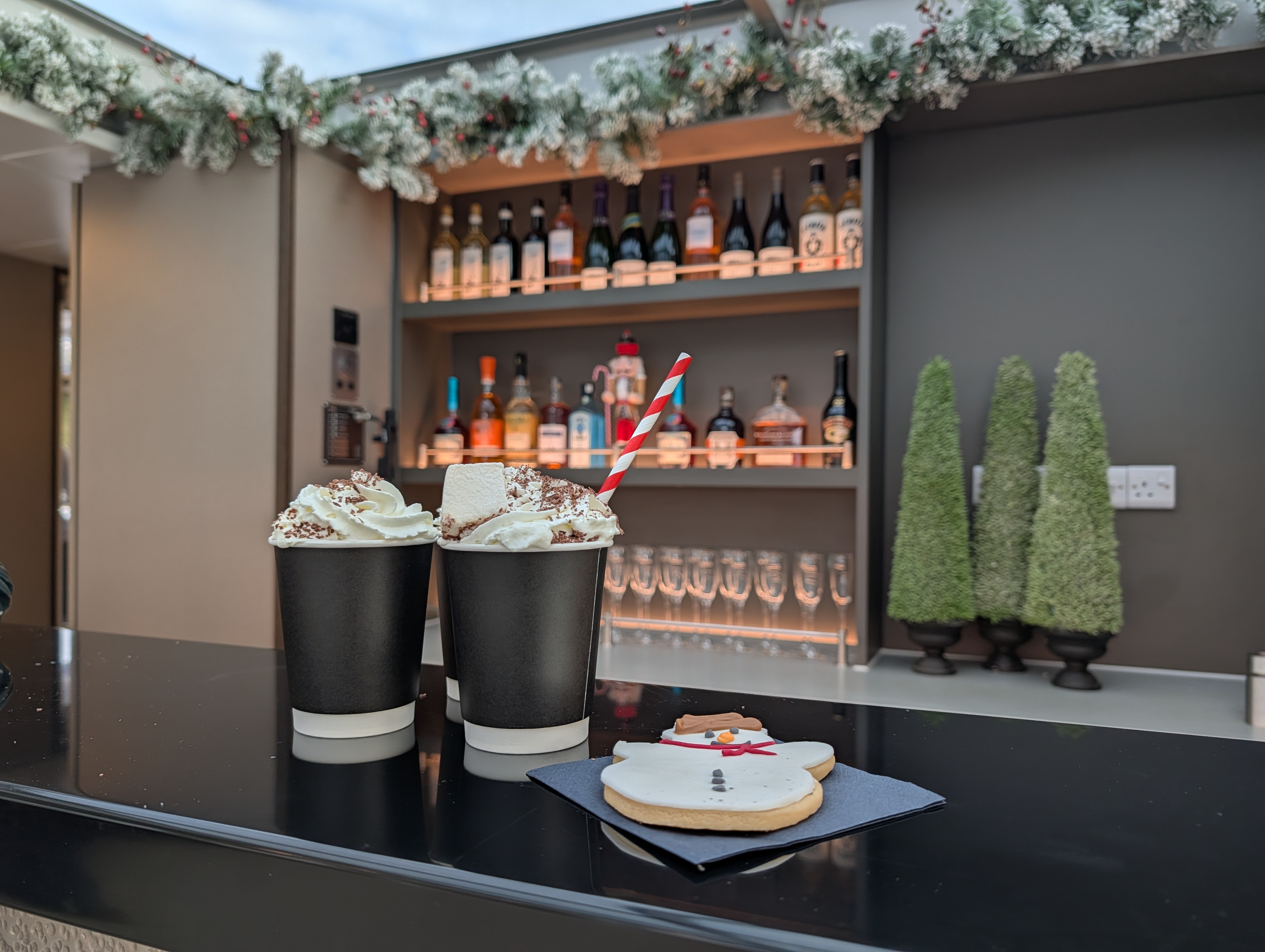 Two luxurious hot chocolates with a snowman biscuit on the Tower of London River Tour onboard bar