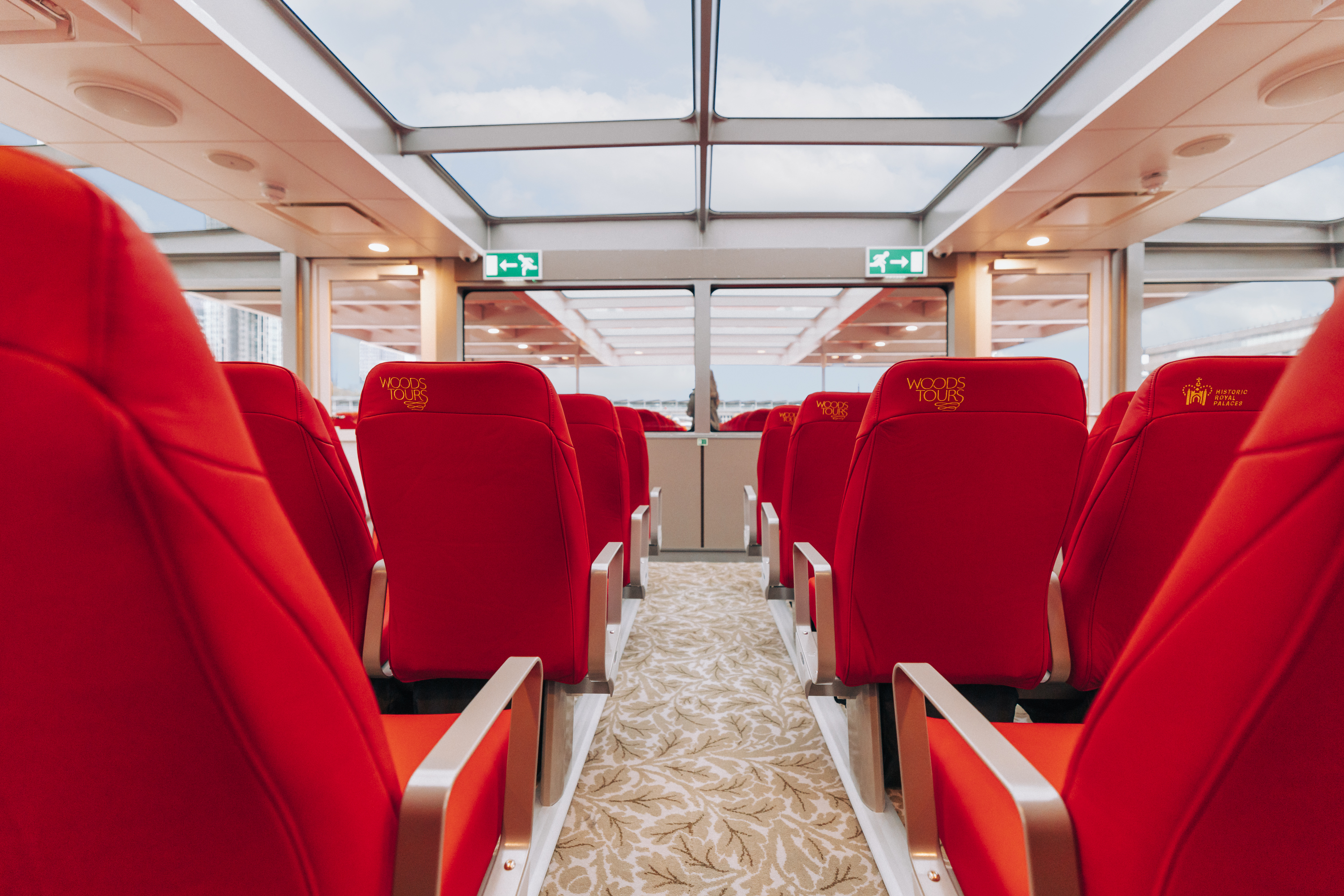 Panoramic views and luxurious scottish eco leather seats in the indoor observation lounge aboard the Tower of London River Tour